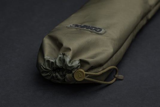 An olive-colored Korda Compac Weigh Sling for fishing in a bag.