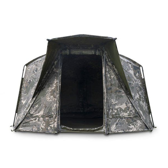 Nash Titan T1 Camo Pro. A camouflage bivvy with an extended awning set up outdoors. Front View