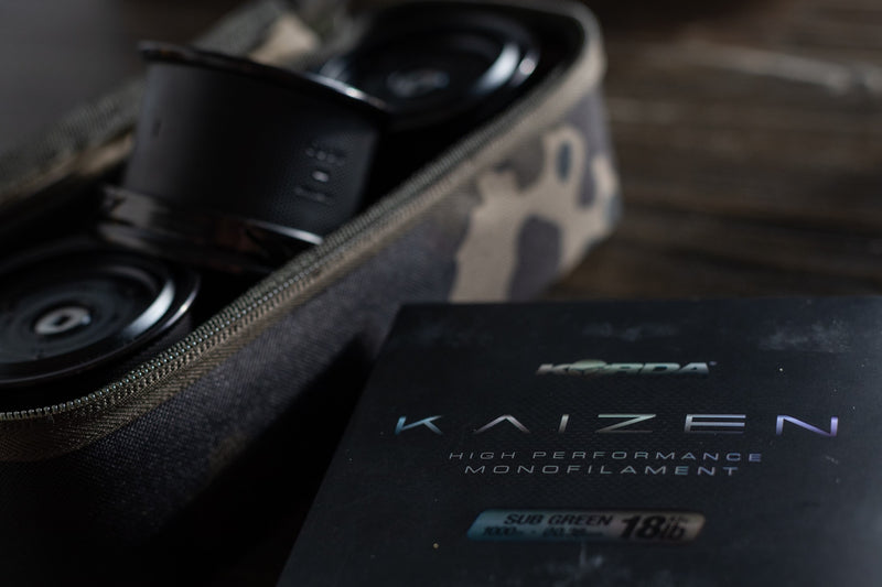 Load image into Gallery viewer, Close-up of a fishing line spool with &#39;Norda Kaizen&#39; branding on a dark background
