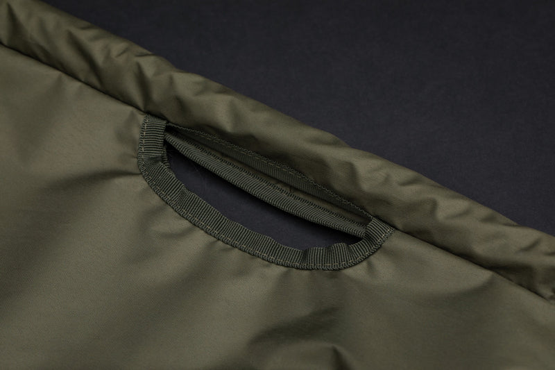 Load image into Gallery viewer, An olive-colored Korda Compac Weigh Sling for fishing, and grab handles. 
