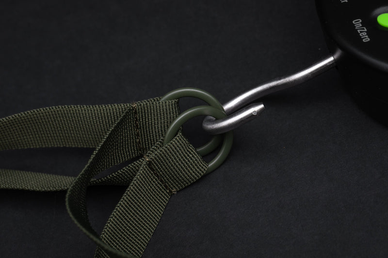 Load image into Gallery viewer, An olive-colored Korda Compac Weigh Sling for fishing, with a hanging loop, quick-release zips, and grab handles. Hooking Points
