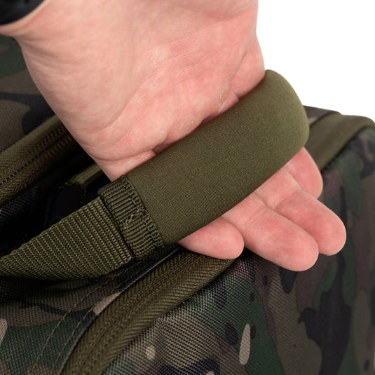 A Trakker NXC Camo Pro Carryall Medium fishing bag with camouflage pattern in a green colour. Holding Handle Zoom in