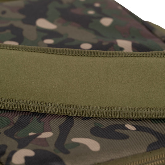A Trakker NXC Camo Pro Carryall Medium fishing bag with camouflage pattern in a green colour. Zoom in on strap stich