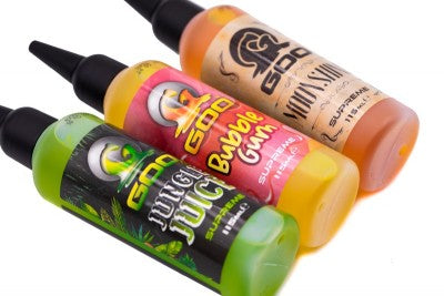 Load image into Gallery viewer, Multiple bottles of Korda Goo in various colors, designed for use in fishing, labeled with the brand and product name. Jungle Juice, Bubble Gum, Moonshine
